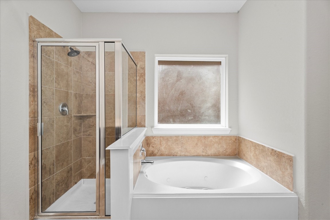 23502 Breckenridge Dale Lane Spring, TX 77373 - Photo 15 of 24 a bathroom with a bathtub and shower