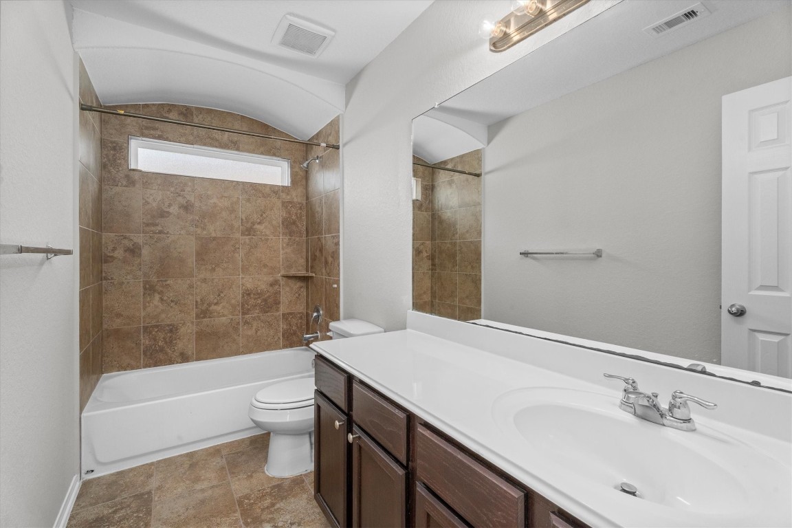 23502 Breckenridge Dale Lane Spring, TX 77373 - Photo 21 of 24 a bathroom with a bathtub shower sink mirror vanity and toilet