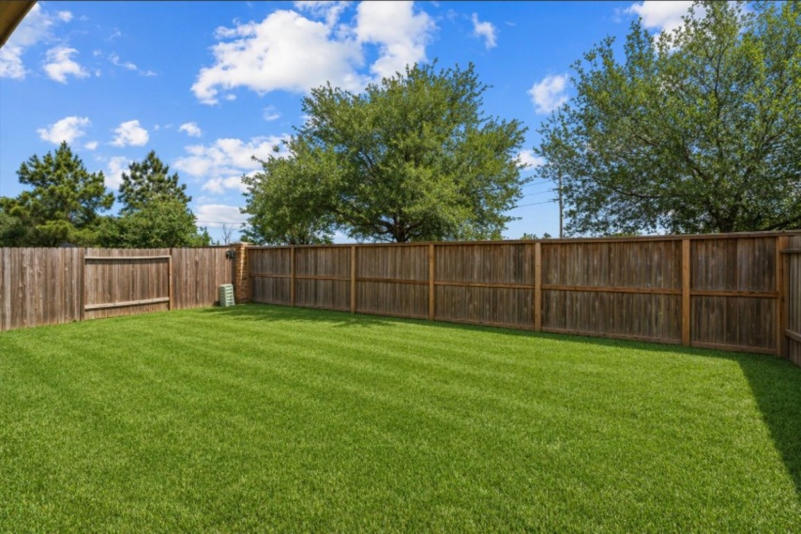 23502 Breckenridge Dale Lane Spring, TX 77373 - Photo 23 of 24 a view of a backyard with wooden fence