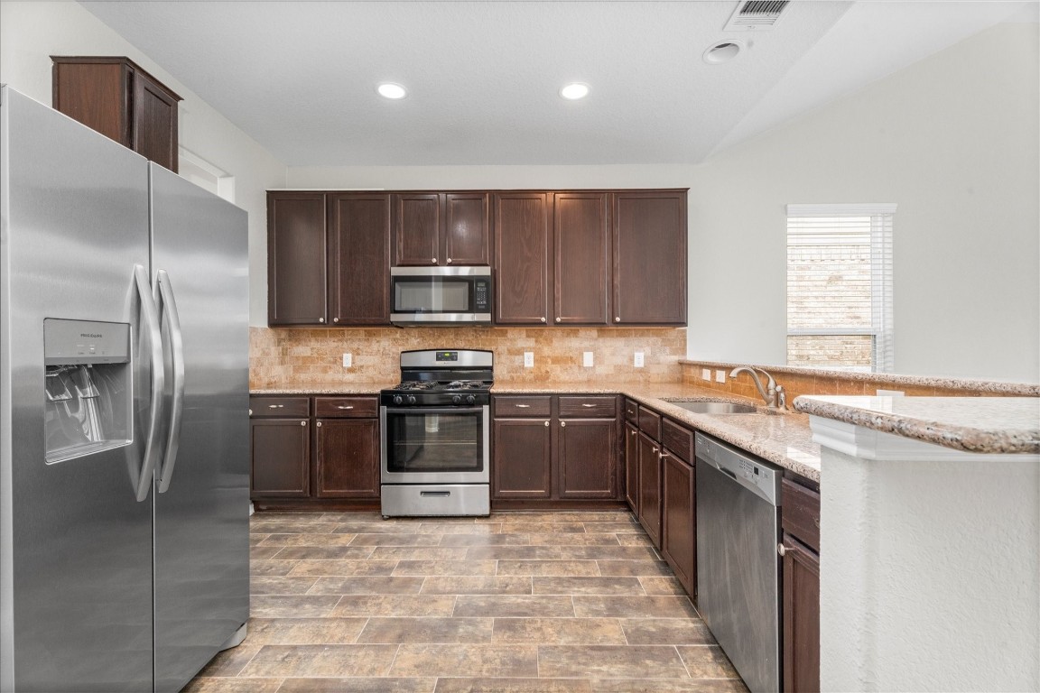 23502 Breckenridge Dale Lane Spring, TX 77373 - Photo 7 of 24 a kitchen with stainless steel appliances granite countertop a refrigerator and a sink