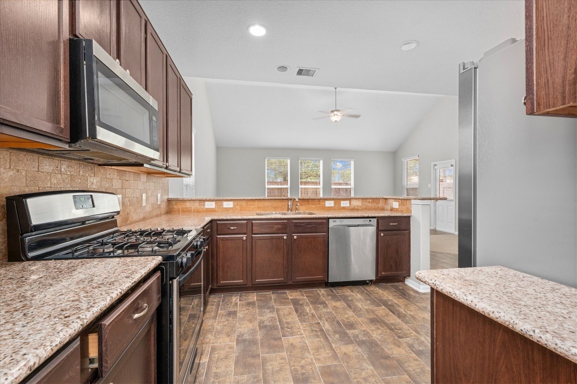23502 Breckenridge Dale Lane Spring, TX 77373 - Photo 8 of 24 a kitchen with a sink stove and refrigerator
