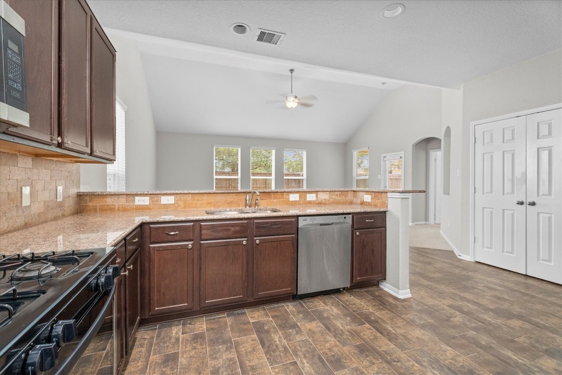 23502 Breckenridge Dale Lane Spring, TX 77373 - Photo 9 of 24 a large kitchen with stainless steel appliances granite countertop a stove and a sink