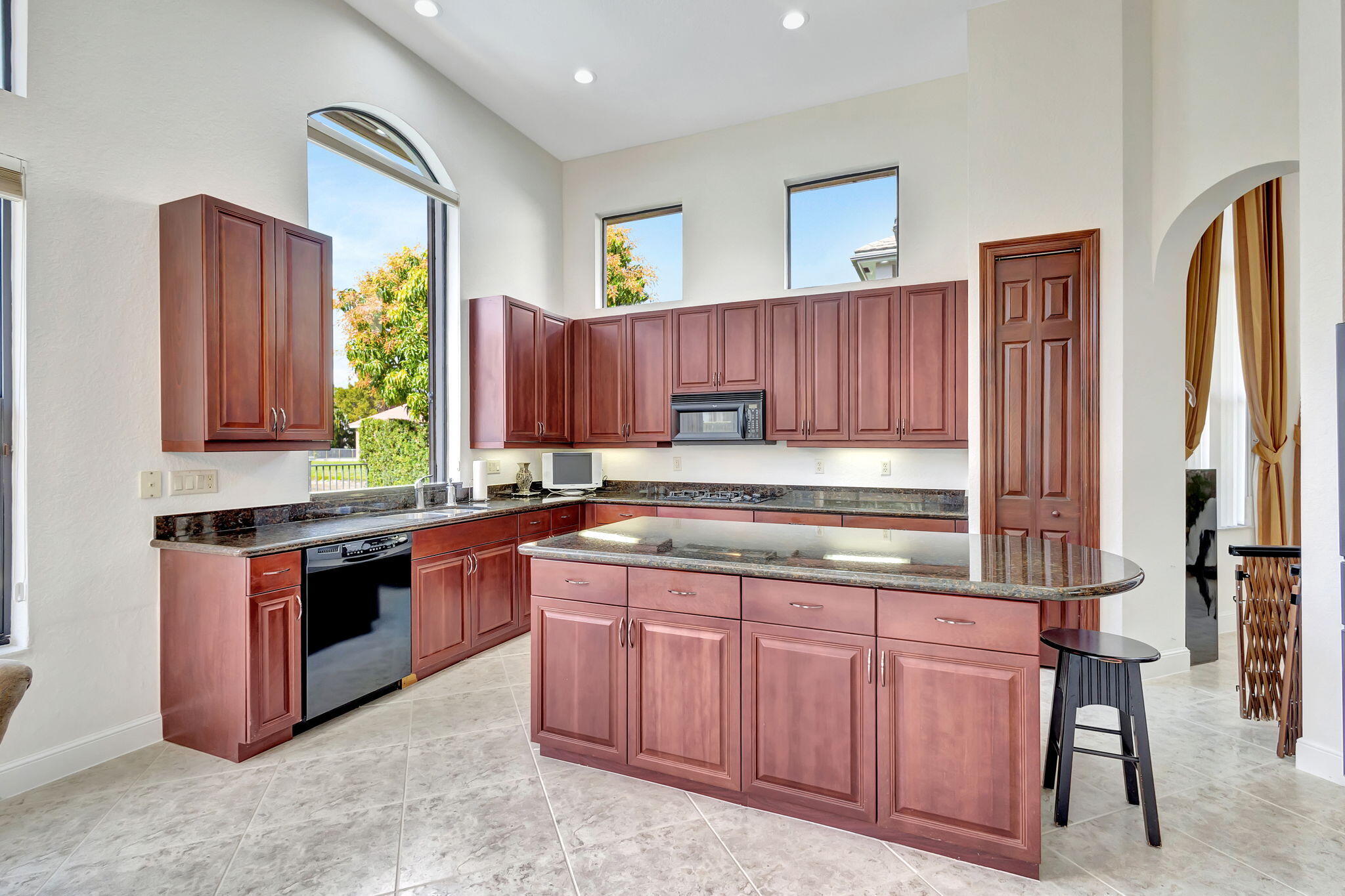 3553 Collonade Drive Wellington, FL 33449 - Photo 17 of 76 a kitchen with stainless steel appliances granite countertop wooden cabinets a stove top oven a sink and dishwasher