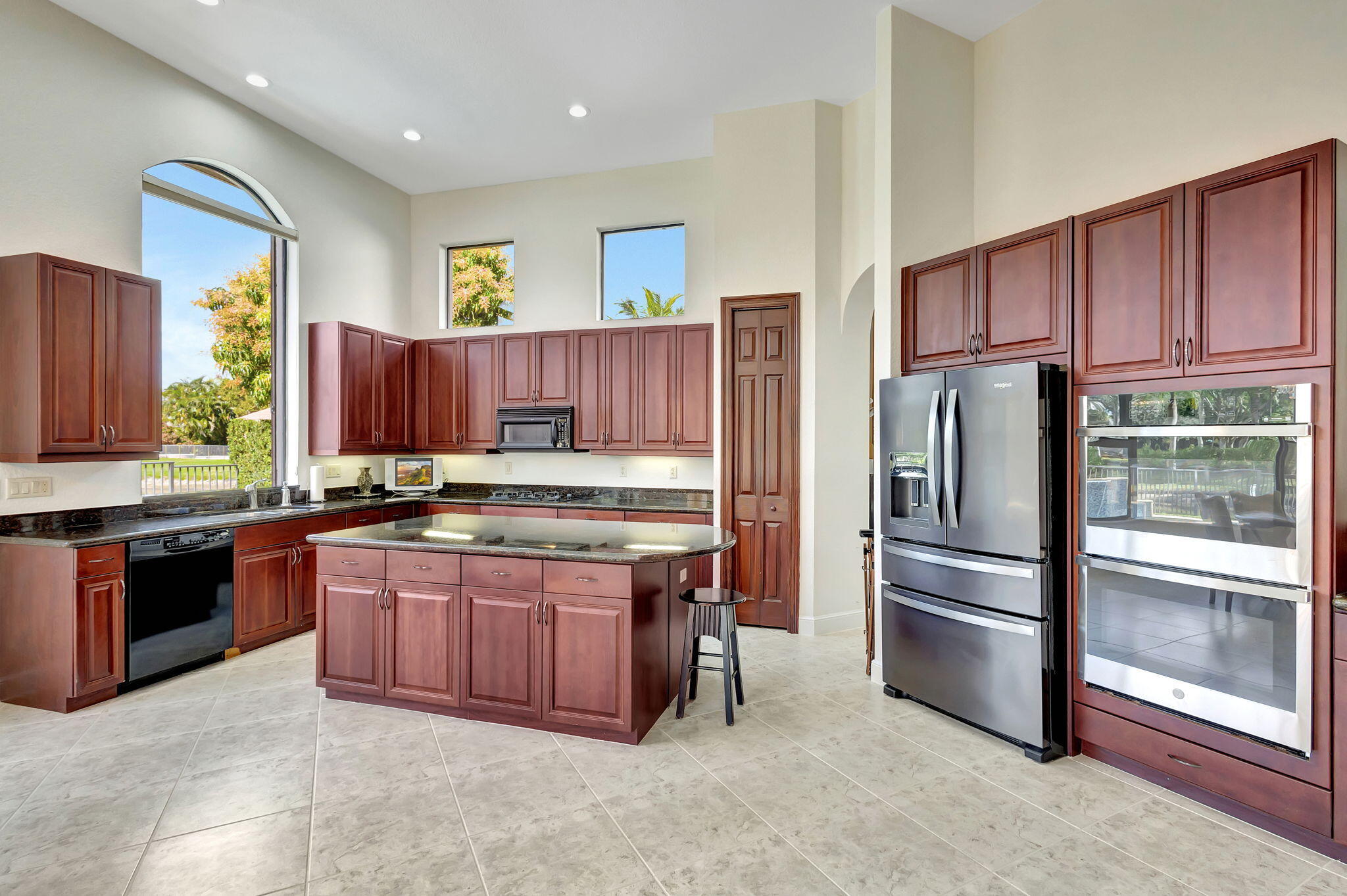 3553 Collonade Drive Wellington, FL 33449 - Photo 19 of 76 a kitchen with stainless steel appliances granite countertop a refrigerator and a stove top oven