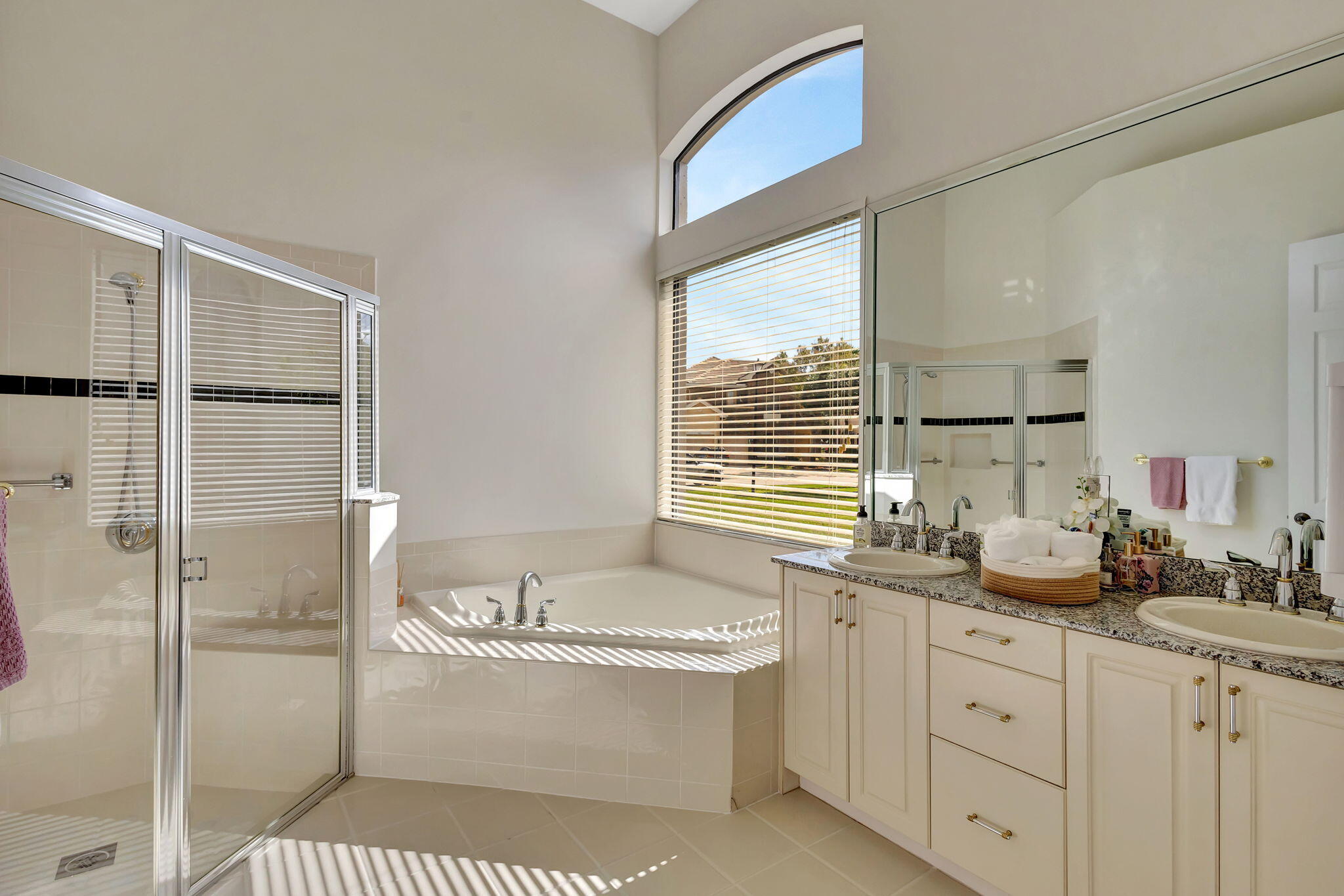 3553 Collonade Drive Wellington, FL 33449 - Photo 28 of 76 a bathroom with a sink a mirror and a shower