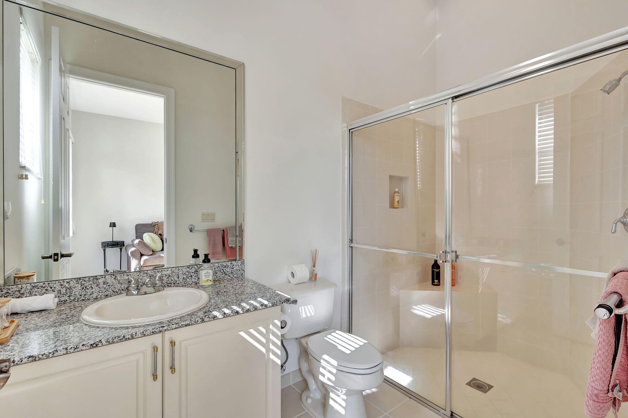 3553 Collonade Drive Wellington, FL 33449 - Photo 38 of 76 a bathroom with a granite countertop sink a toilet and shower