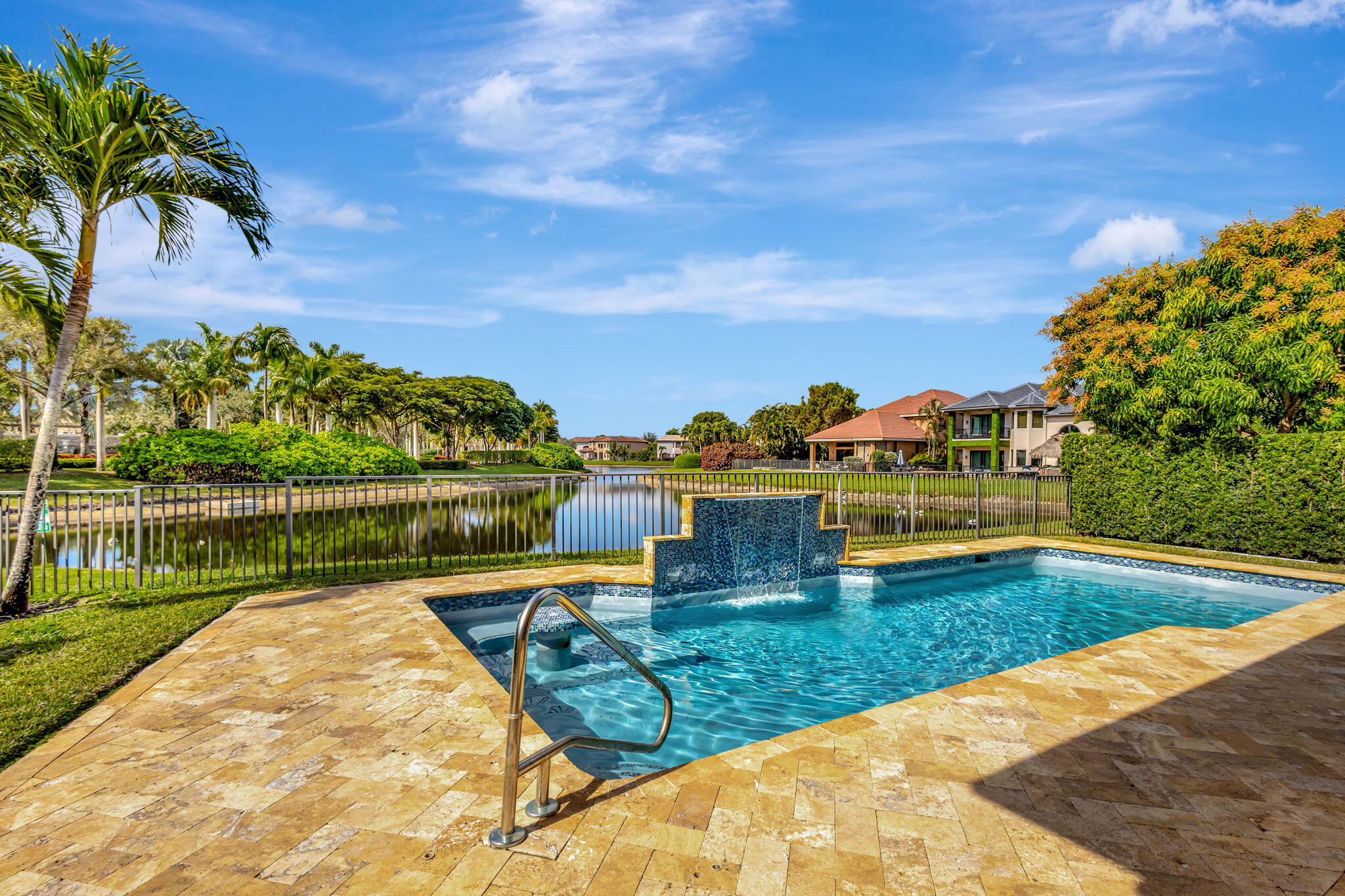 3553 Collonade Drive Wellington, FL 33449 - Photo 42 of 76 a view of swimming pool with a table and chairs next to a yard