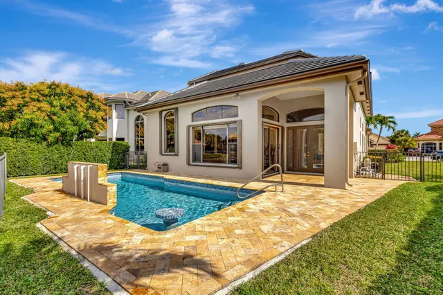 a living room with fireplace furniture and a potted plant