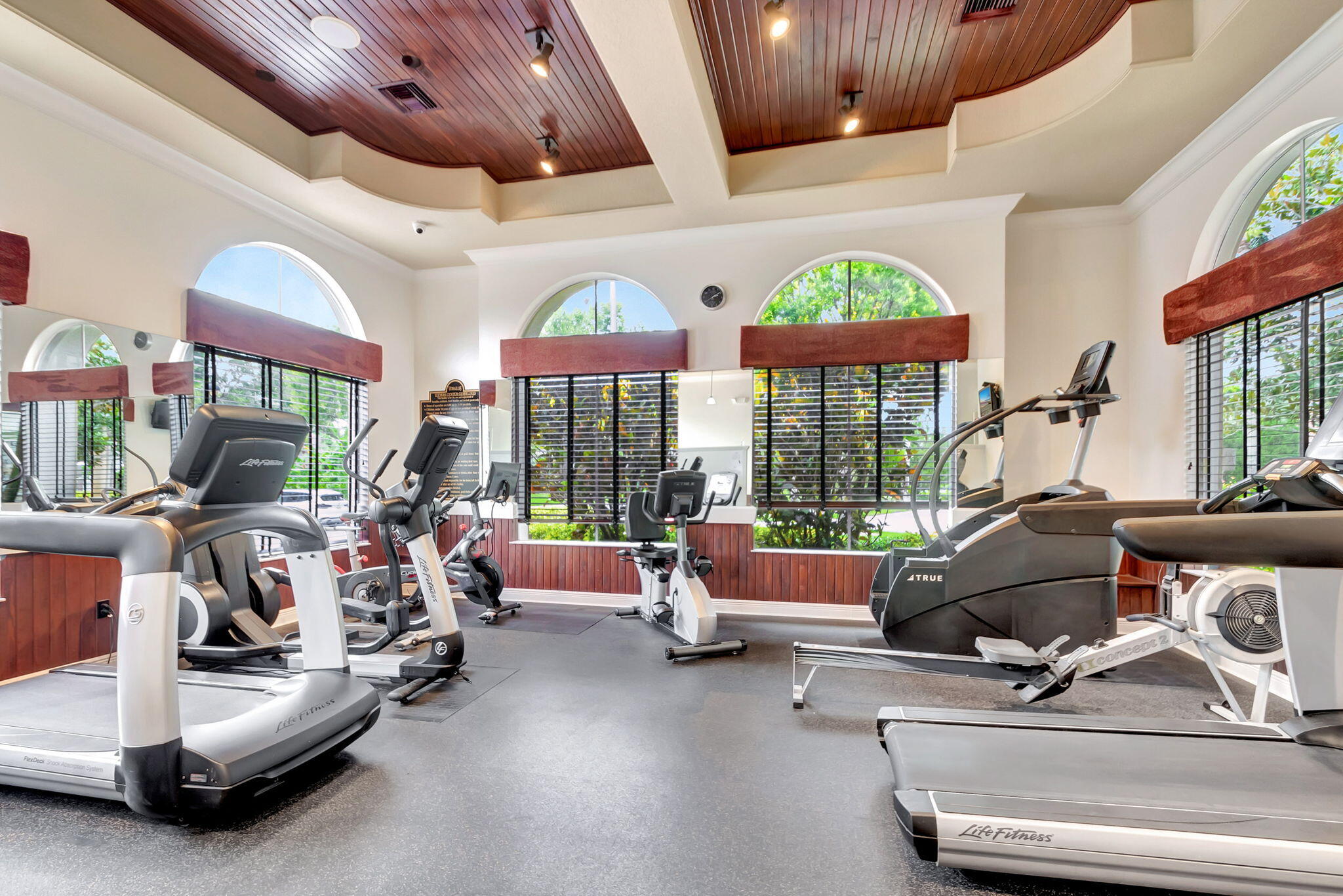 3553 Collonade Drive Wellington, FL 33449 - Photo 64 of 76 a room with gym equipment and a large window