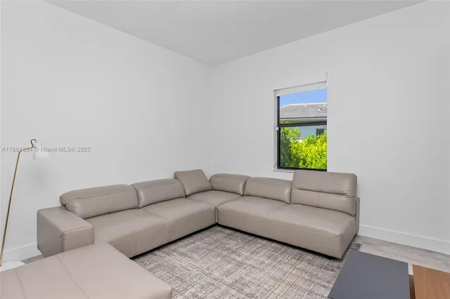 a living room with a couch and a window