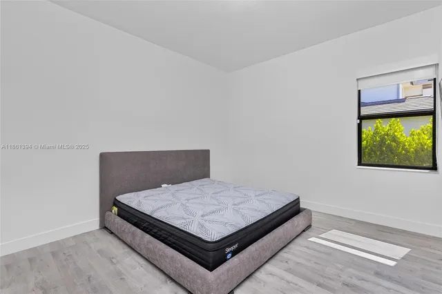 a bedroom with a bed and window