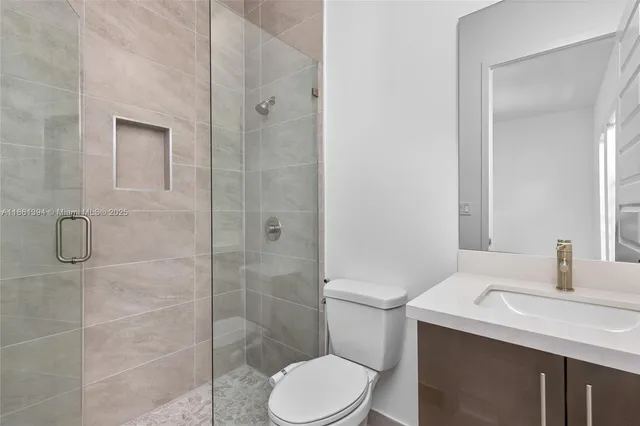 a bathroom with a sink toilet and shower