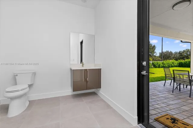 a view of a room with a dining table and chairs