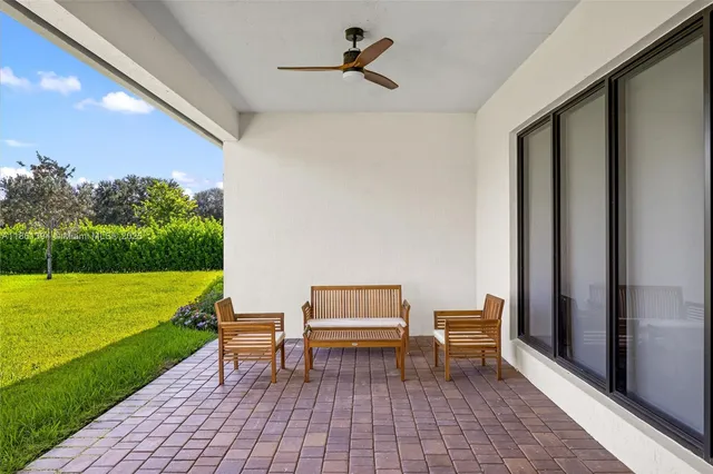 a backyard view with a seating space
