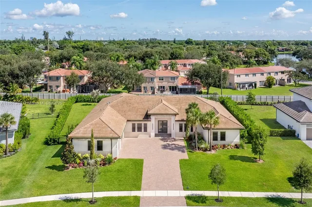 an aerial view of multiple houses with a big yard
