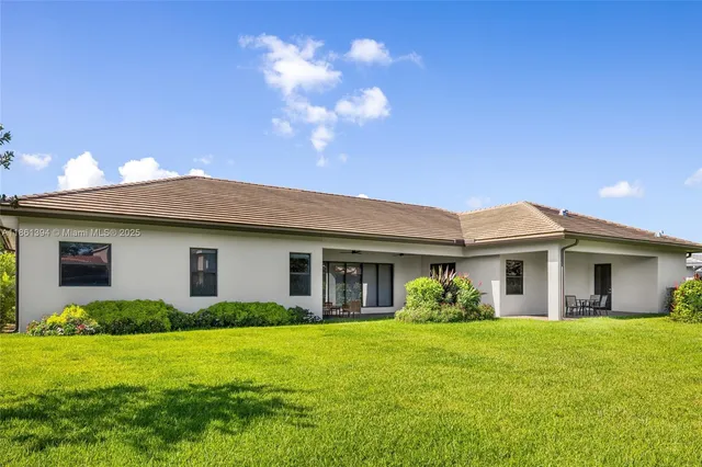 a front view of house with yard and green space