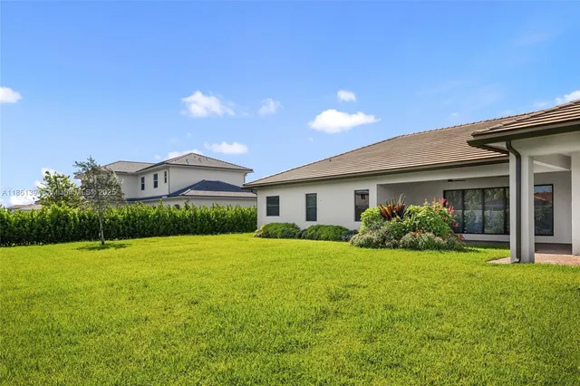 a view of house with yard and green space