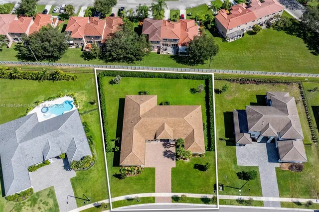 an aerial view of a house with a garden and lake view