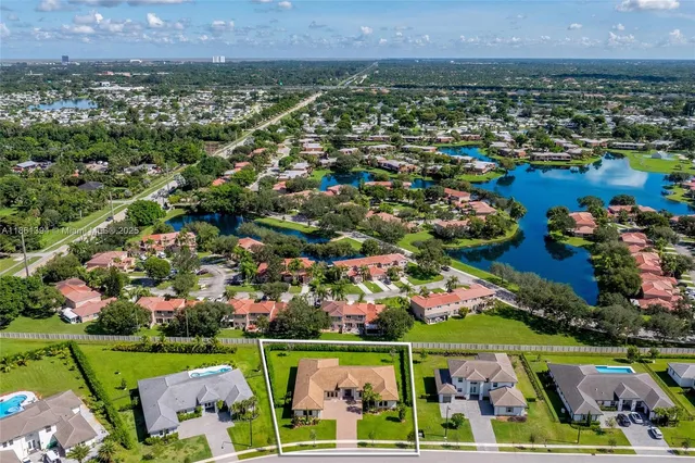 an aerial view of a city with lots of residential buildings and mountain view in back
