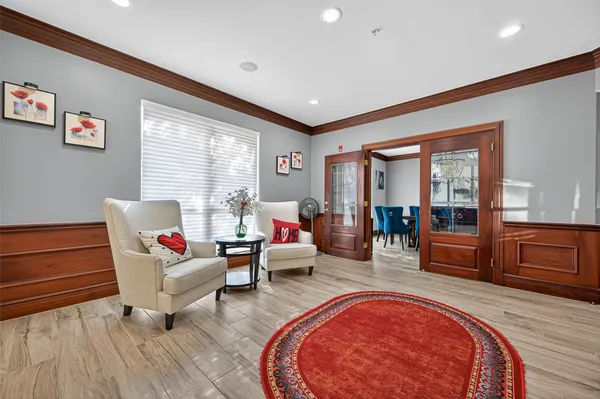 a view of a dining room with furniture chandelier and wooden floor