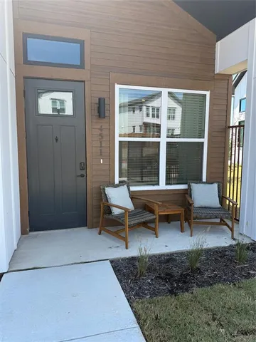 a living room with a rug table and chairs