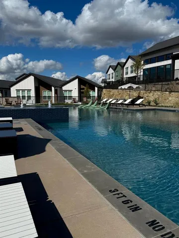a view of swimming pool with outdoor seating