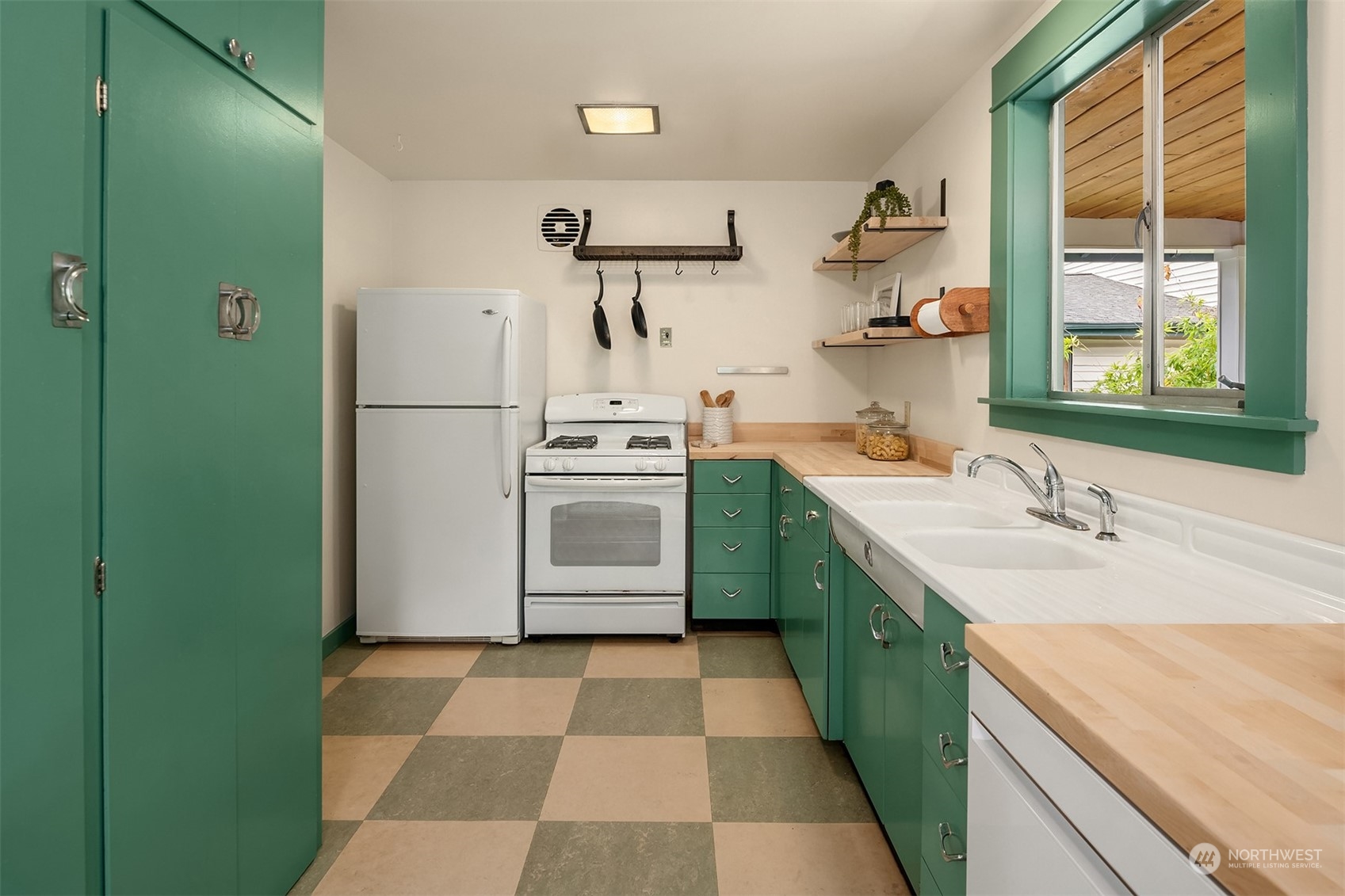 8752 Evanston Avenue North Seattle, WA 98103 - Photo 11 of 29 a kitchen with a sink a refrigerator and window