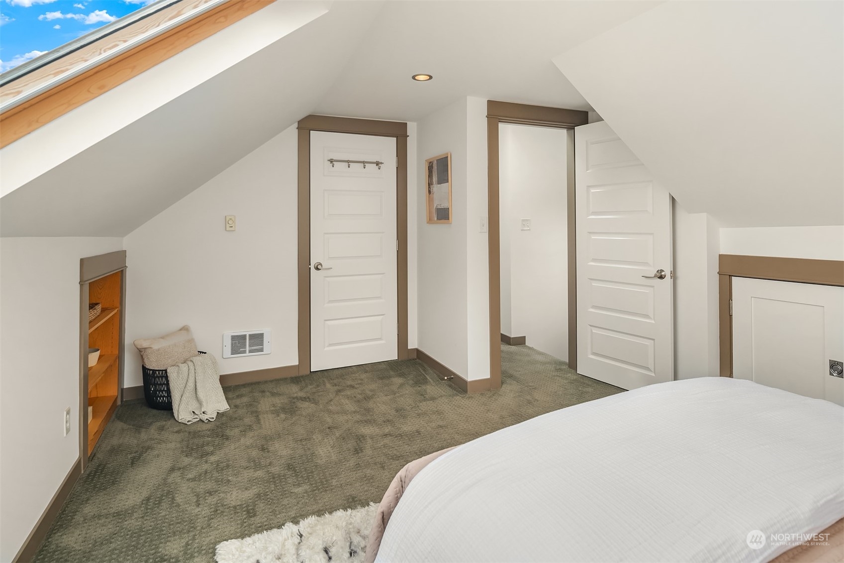 8752 Evanston Avenue North Seattle, WA 98103 - Photo 20 of 29 a bedroom with a large bed and closet