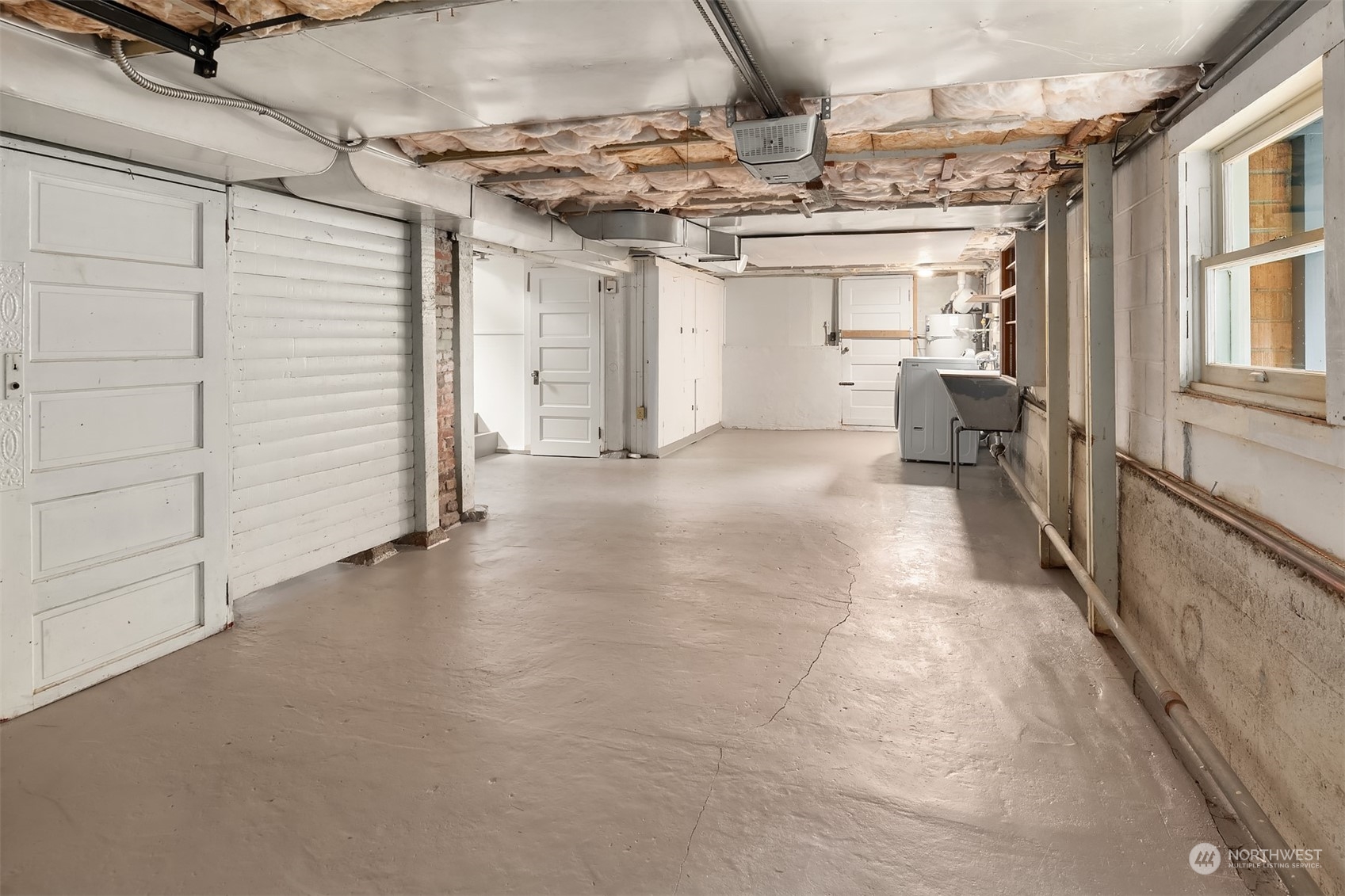 8752 Evanston Avenue North Seattle, WA 98103 - Photo 23 of 29 a view of a hallway with a car parked in garage