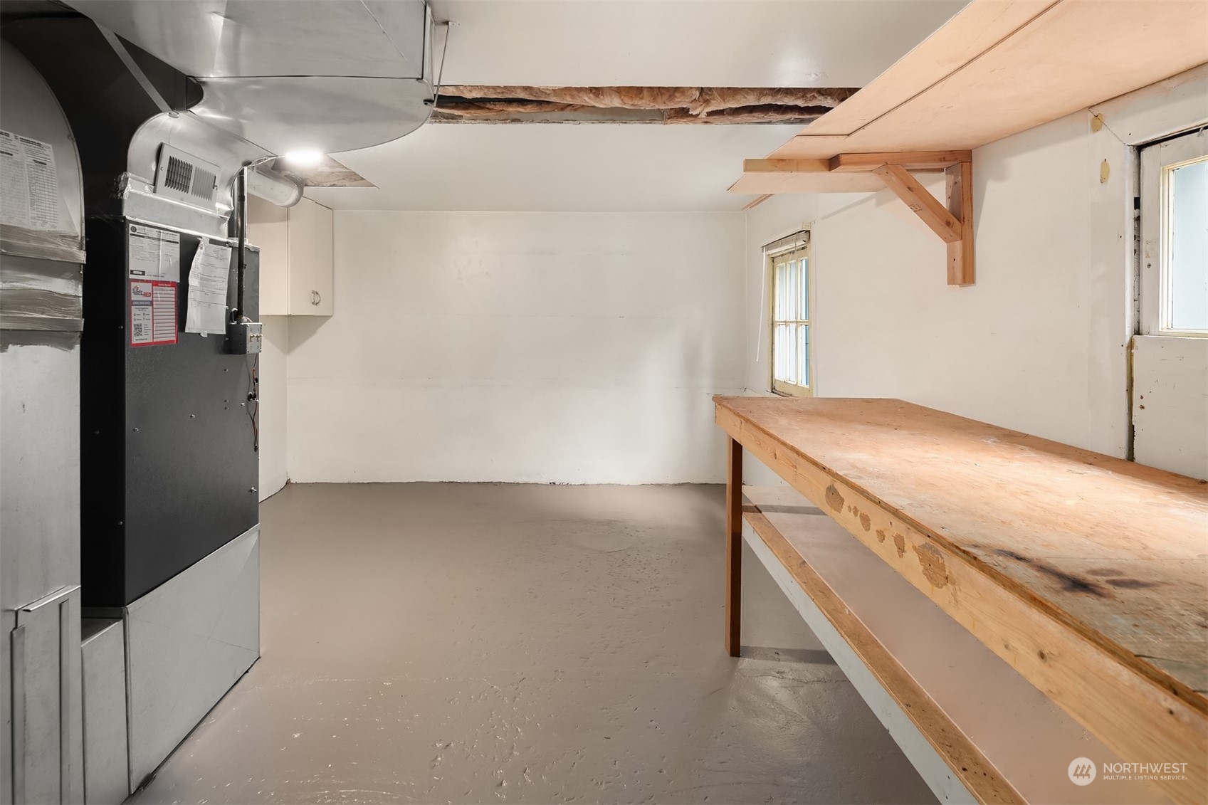8752 Evanston Avenue North Seattle, WA 98103 - Photo 24 of 29 a view of storage and utility room with a washer and dryer