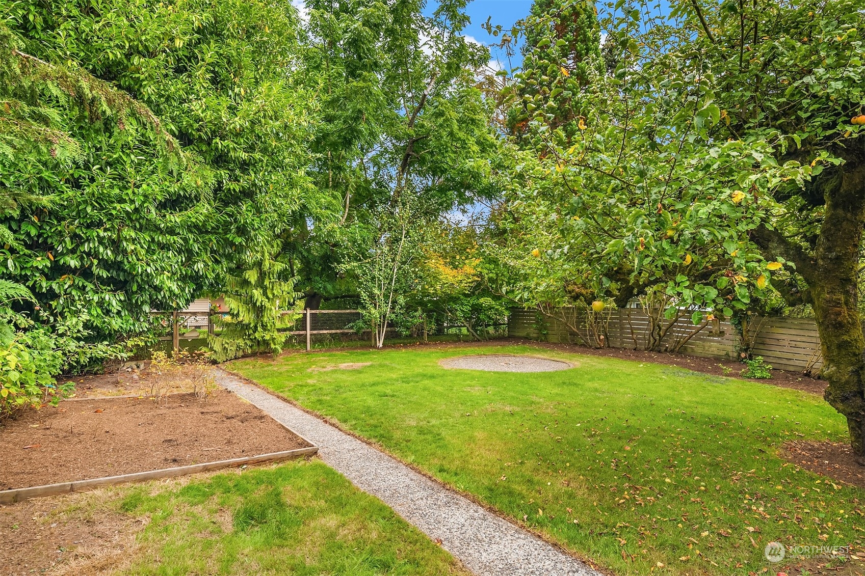 8752 Evanston Avenue North Seattle, WA 98103 - Photo 28 of 29 a view of a backyard with large trees