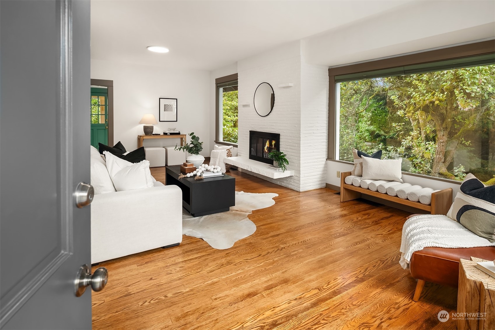 8752 Evanston Avenue North Seattle, WA 98103 - Photo 4 of 29 a living room with furniture large window and a fireplace