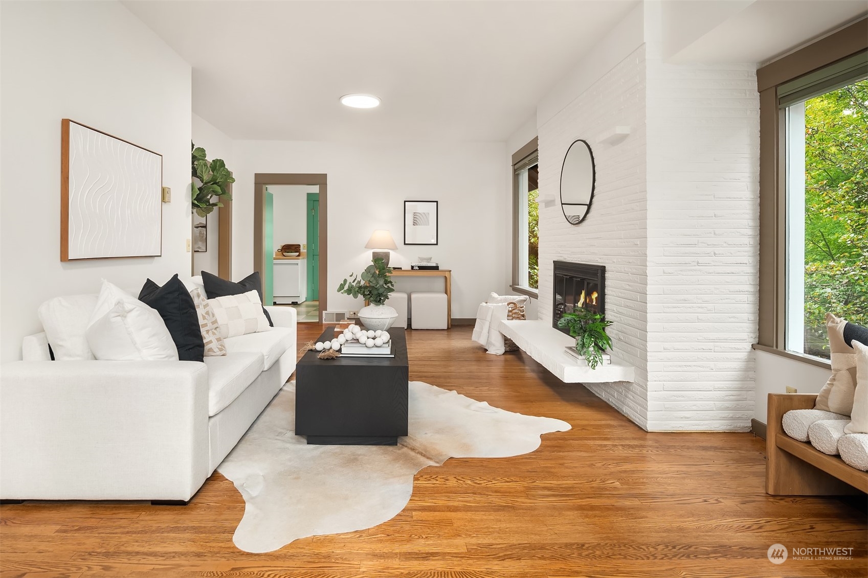 8752 Evanston Avenue North Seattle, WA 98103 - Photo 5 of 29 a living room with furniture and a fireplace