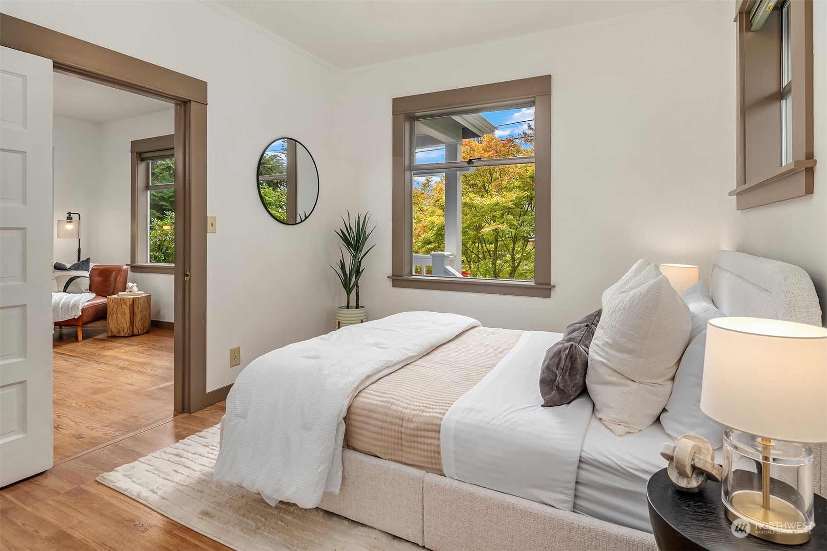 8752 Evanston Avenue North Seattle, WA 98103 - Photo 9 of 29 a bedroom with a bed mirror and window