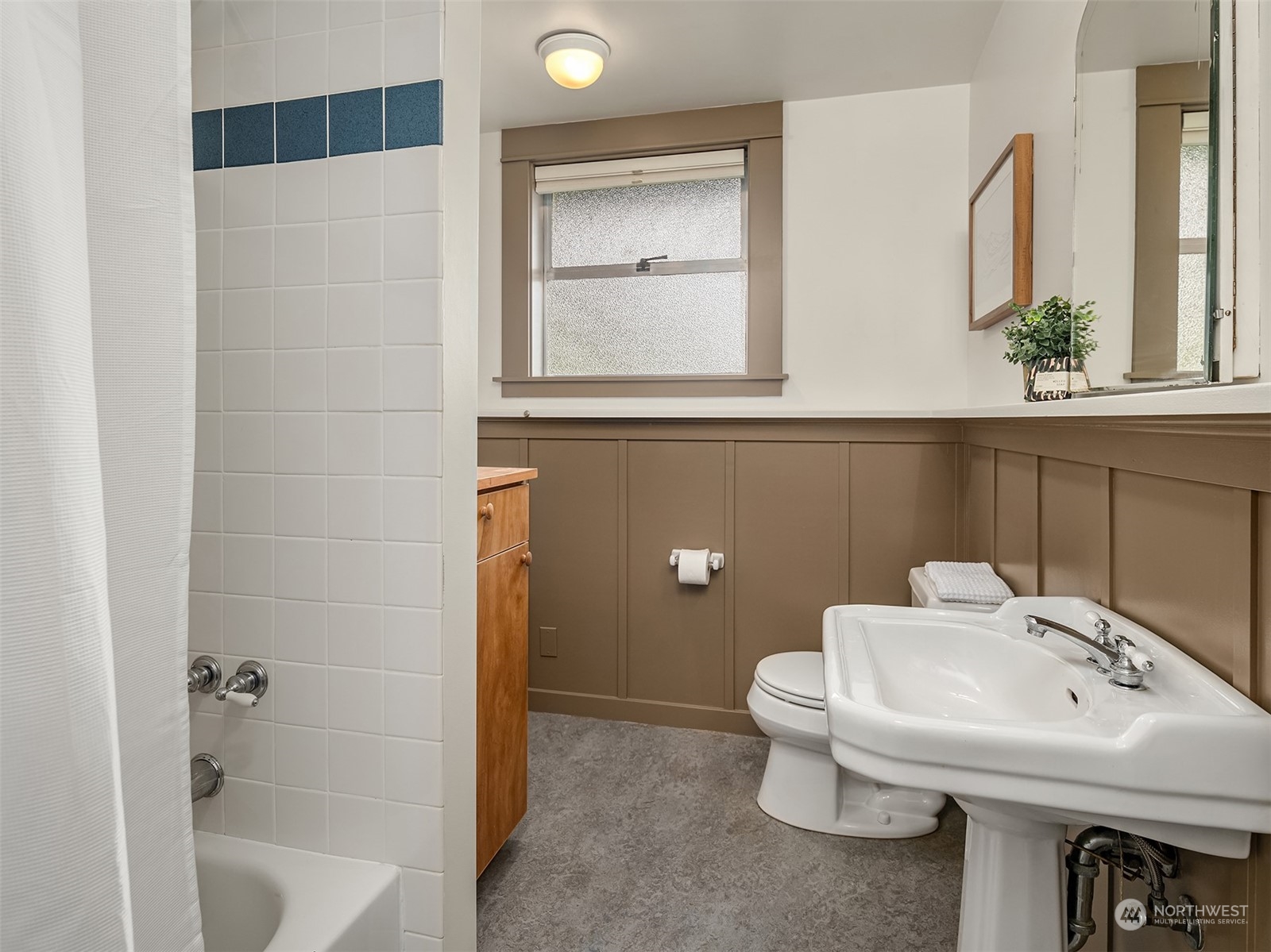 8752 Evanston Avenue North Seattle, WA 98103 - Photo 10 of 29 a bathroom with a sink toilet and shower