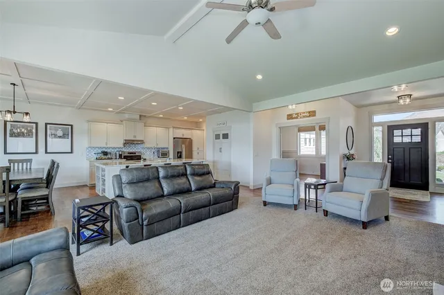 a living room with furniture and a view of kitchen