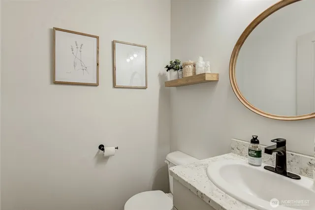 a bathroom with a sink mirror and toilet