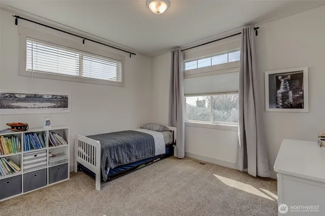 a living room with a bed and a window