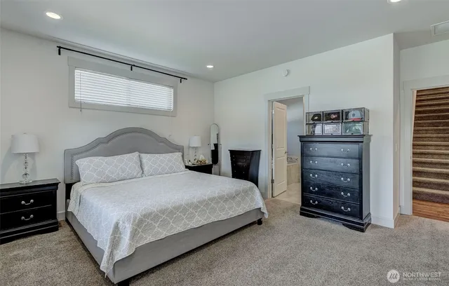 a bedroom with a bed and a mirror