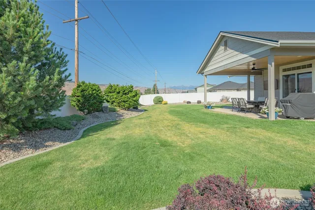 a view of a house with a yard and sitting area