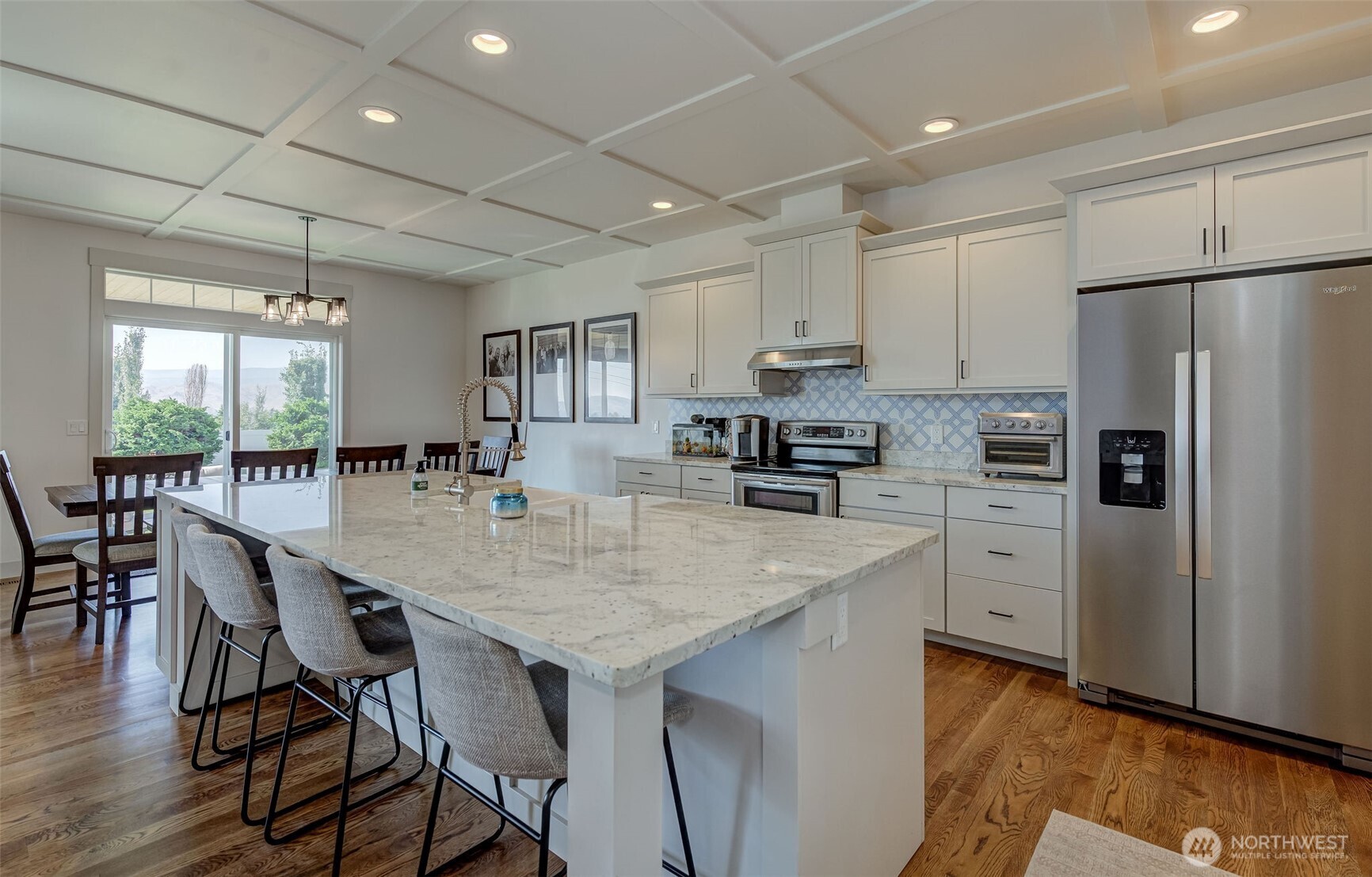 826 Autumn Crest Drive Wenatchee, WA 98801 - Photo 8 of 38 a kitchen with stainless steel appliances a table chairs refrigerator and wooden cabinets
