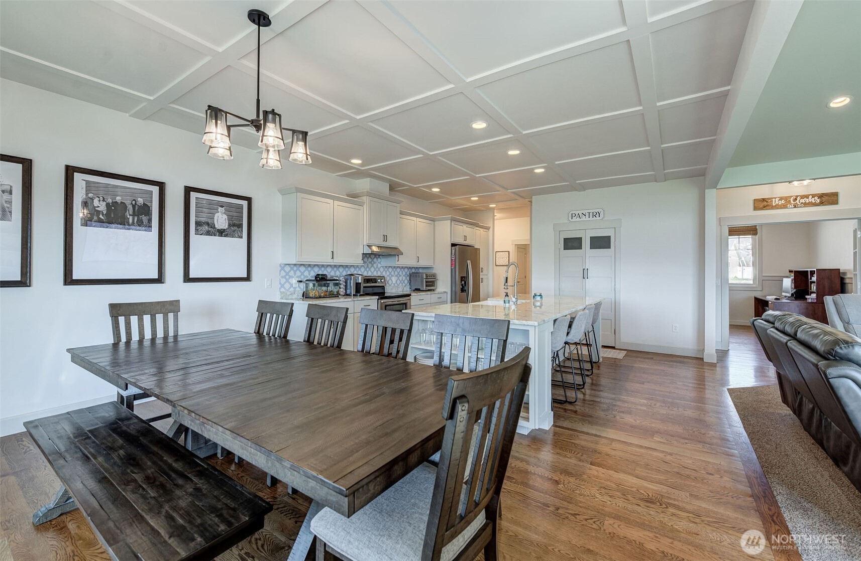 826 Autumn Crest Drive Wenatchee, WA 98801 - Photo 10 of 38 a dining room with wooden floor a chandelier a wooden table and chairs