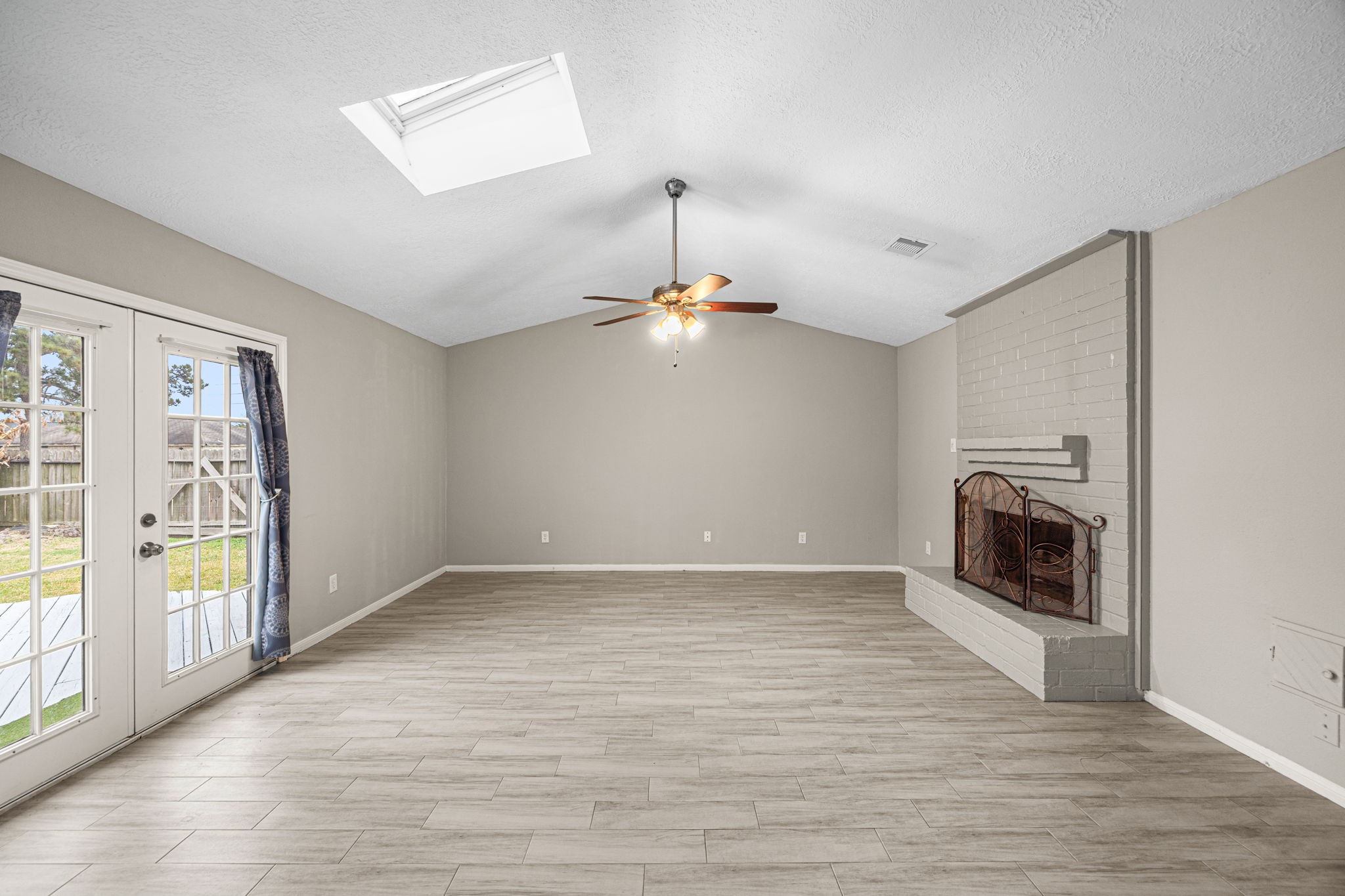 2302 Marble Falls Drive Spring, TX 77373 - Photo 15 of 24 a view of empty room with wooden floor and fireplace