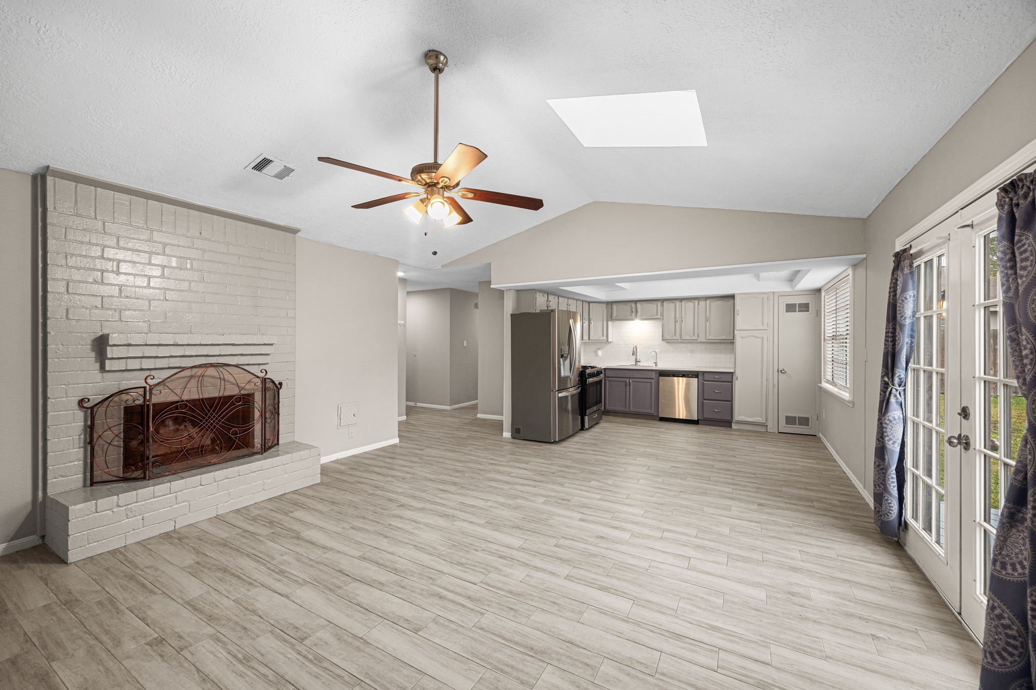 2302 Marble Falls Drive Spring, TX 77373 - Photo 17 of 24 a view of a livingroom with a fireplace a ceiling fan and wooden floor