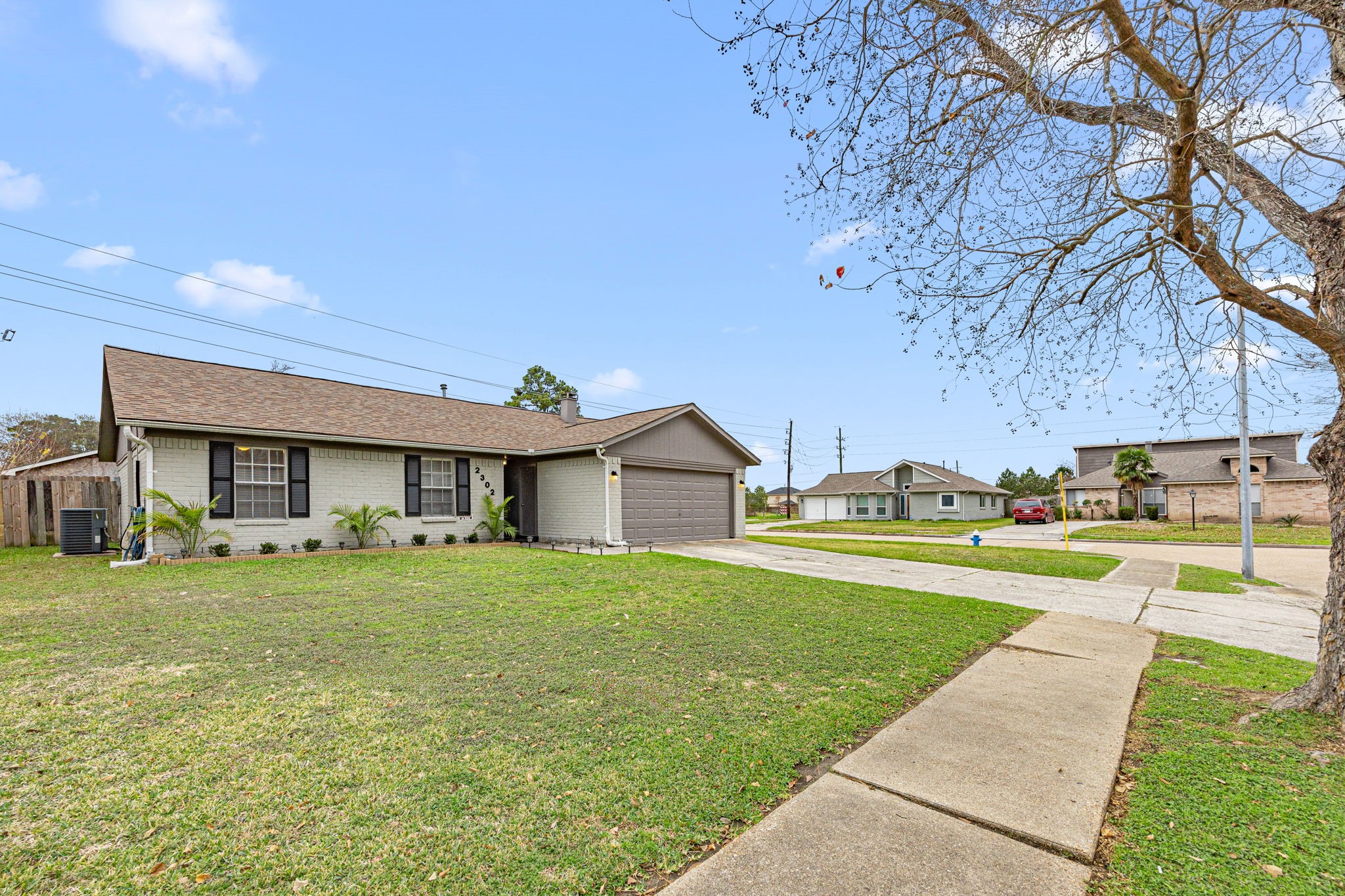 2302 Marble Falls Drive Spring, TX 77373 - Photo 4 of 24 a view of a big house with a big yard and large tree