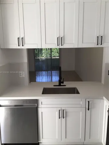 a kitchen with stainless steel appliances a sink and cabinets