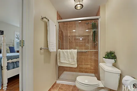 a bathroom with a toilet and a shower