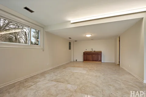a big room with chandelier and windows
