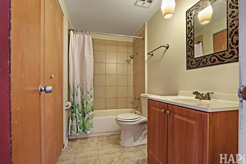 a bathroom with a toilet sink and shower