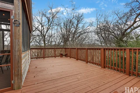 a balcony with wooden floor and fence